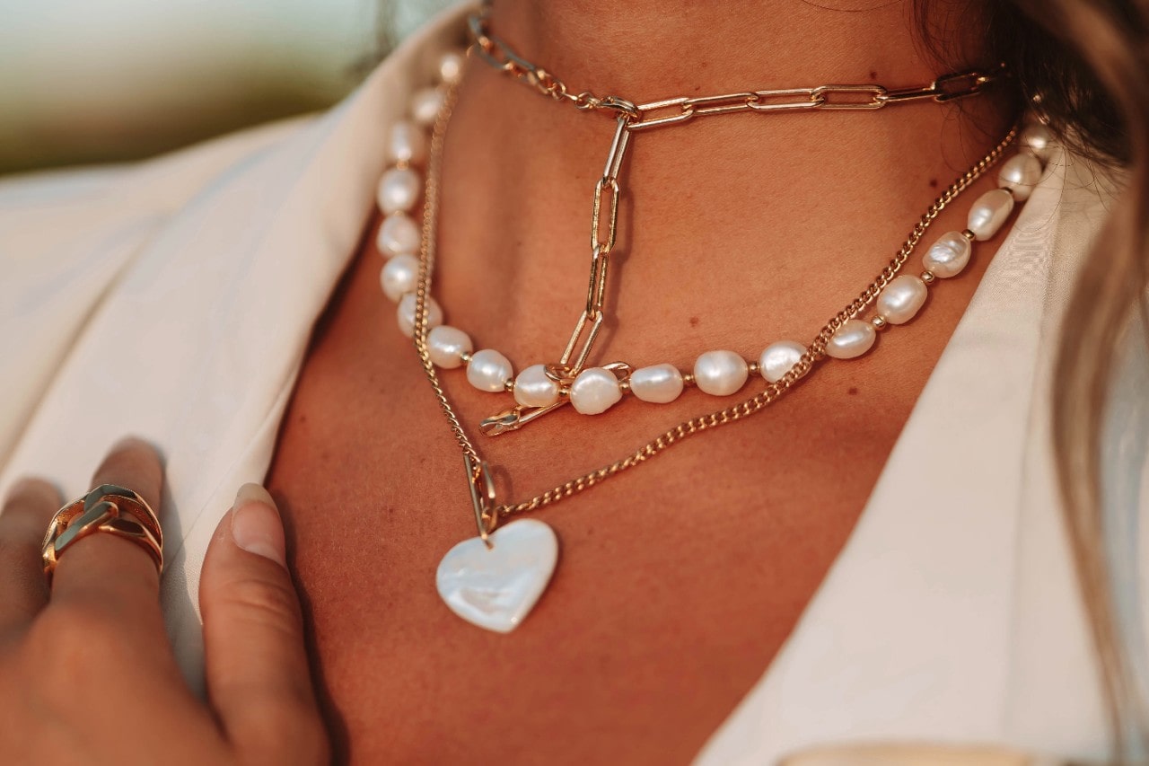 Pearl and chain accents make these three gold and pearl necklaces stand out yet stay cohesive