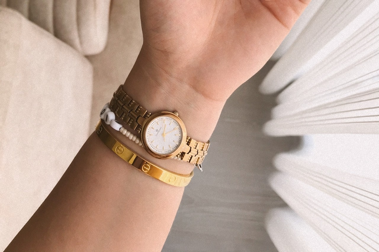 A woman’s wrist wearing a watch and bracelets