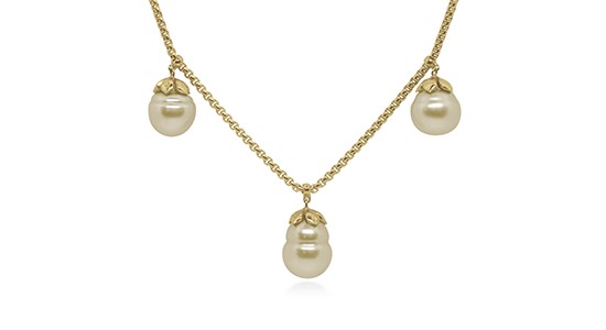 A yellow gold chain necklace featuring three South Sea pearls