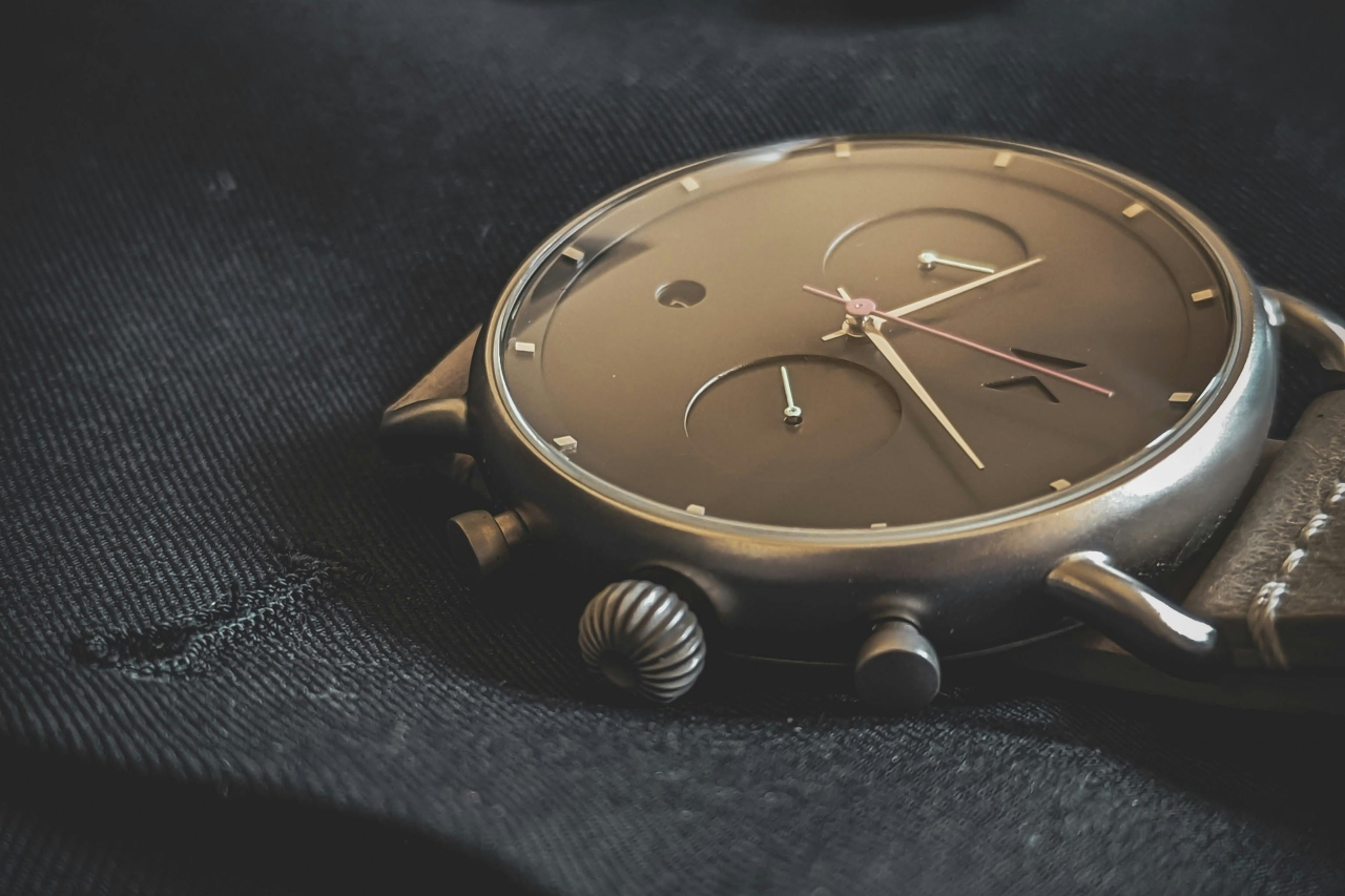 A luxury watch resting atop a dark jacket.