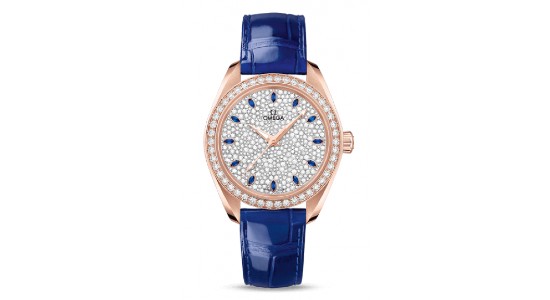 a rose gold watch with a blue strap and gemstone studded dial