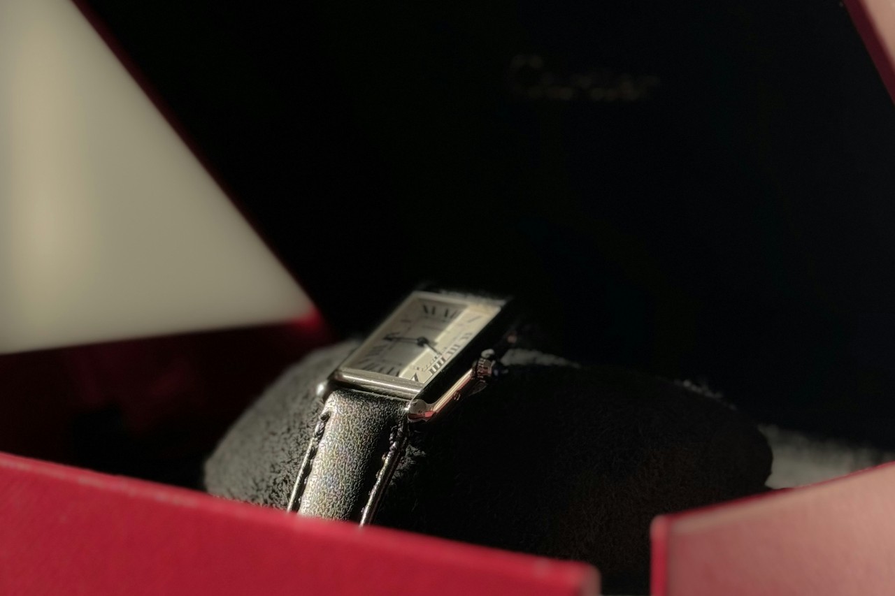 close up image of a square case Cartier watch in a red box