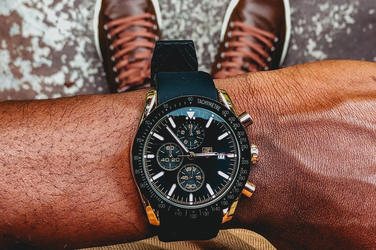 a man’s wrist wearing a Breitling watch