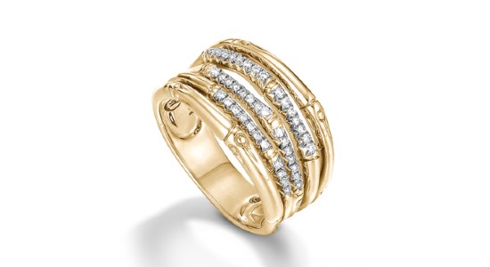 a textured yellow gold gold statement ring with diamond accents