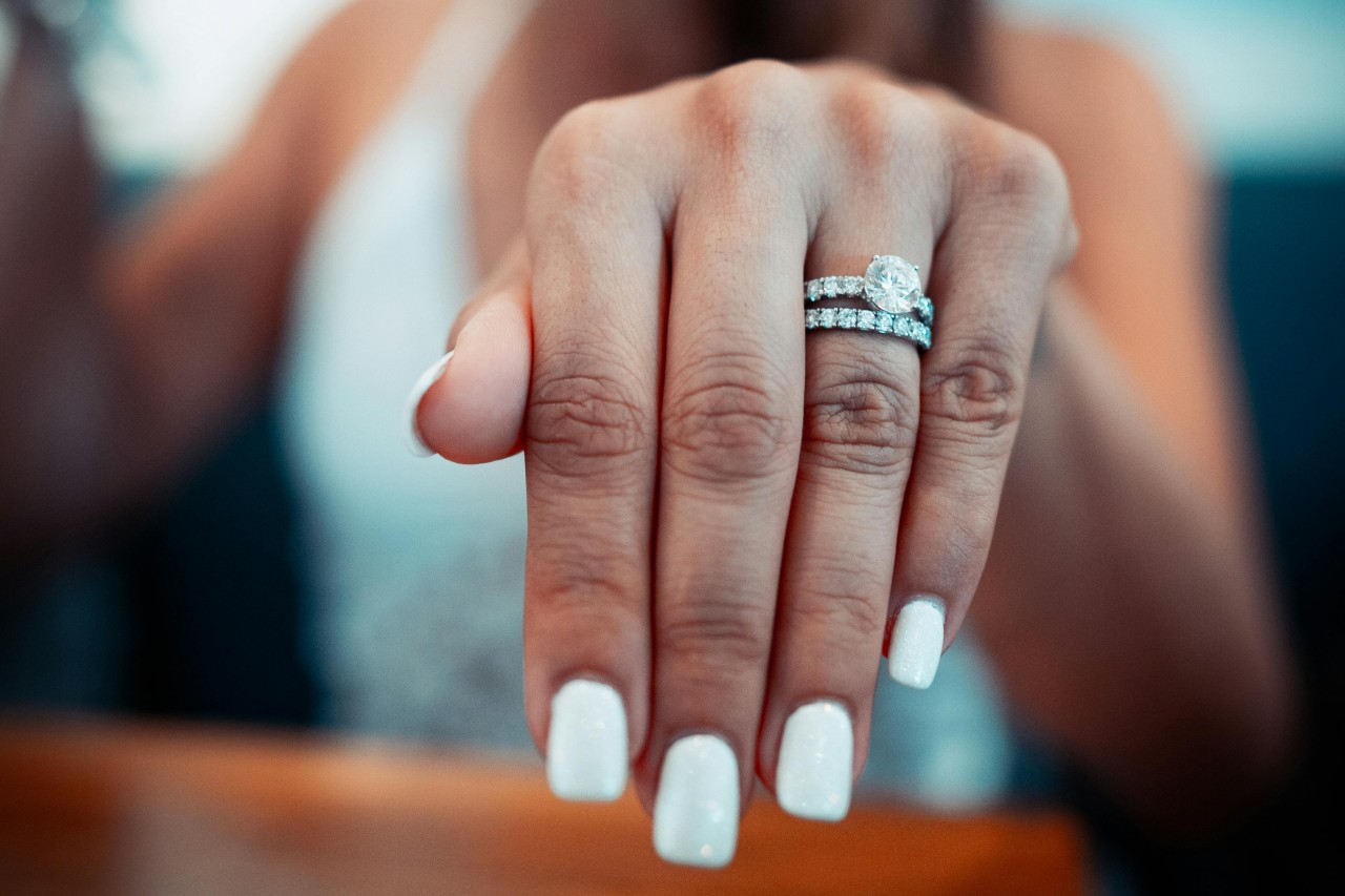 A close-up of a stunning engagement ring on a bride-to-be’s finger.