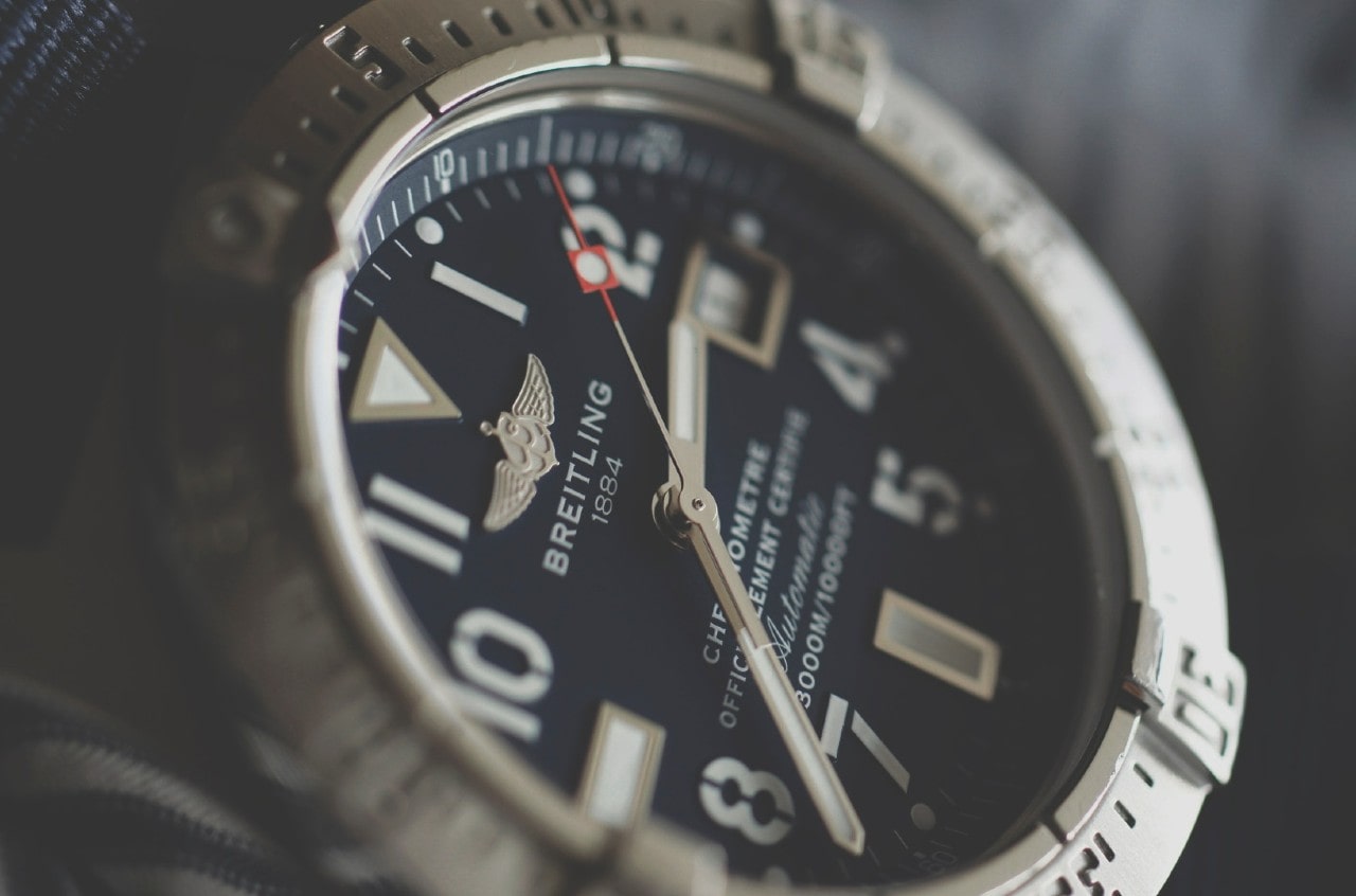 A close-up of a simple yet elegant Breitling wristwatch.