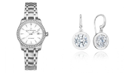 a silver and diamond watch next to glistening diamond earrings